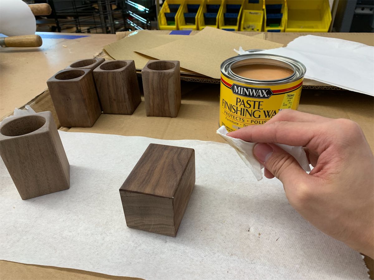 applying wax paste to the wood