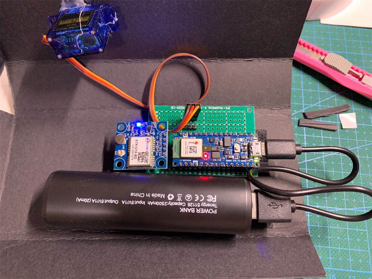 a black box, insides are the arduino, servo and battery connected together